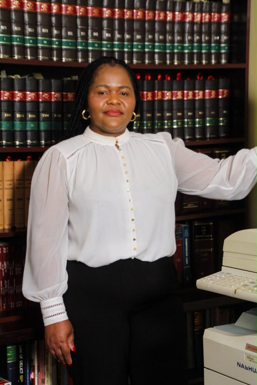 Mrs Ngento in the firm's library